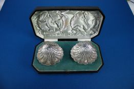 PAIR OF LATE VICTORIAN SILVER SCOLLAP SHELL SHAPED DISHES, chased and repousse and with radiating