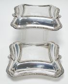 A PAIR OF EDWARDIAN ELECTROPLATED GADROONED EDGE ENTREE DISHES, with scallop handled covers (2)
