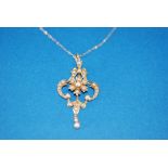 EDWARDIAN 15ct GOLD AND SEED PEARL PENDANT, of openwork scroll pattern with floral centre and