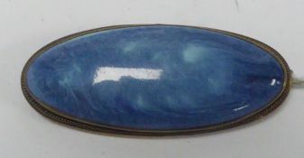 C AND L. KENSINGTON ART. WARE RUSKIN ARTS AND CRAFTS BROOCH, set with a blue glazed long cabochon