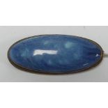 C AND L. KENSINGTON ART. WARE RUSKIN ARTS AND CRAFTS BROOCH, set with a blue glazed long cabochon