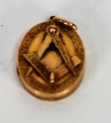 EARLY 20th CENTURY GOLD COLOURED METAL OVAL LOCKET with classical border and applied with Masonic