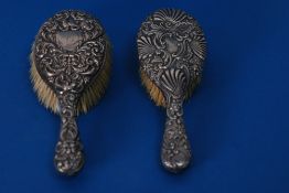 TWO EDWARD VII EMBOSSED SILVER BACKED HAIR BRUSHES (2)