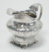 EARLY VICTORIAN SILVER PYRIFORM MILK JUG, the shoulder repousse with flowers and rococo scrolls,