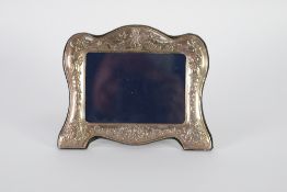 EMBOSSED SILVER FRONTED PHOTOGRAPH FRAME, with blue plush lined easel support, decorated with