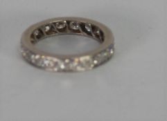 PLATINUM AND DIAMOND ETERNITY RING, set with eighteen round brilliant cut diamonds, each approx .