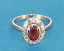 ANTIQUE GOLD COLOURED METAL CLUSTER RING, set with centre oval red stone and surround of sixteen