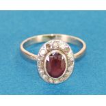 ANTIQUE GOLD COLOURED METAL CLUSTER RING, set with centre oval red stone and surround of sixteen
