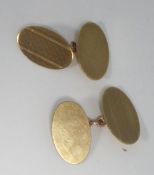 A PAIR OF 9ct GOLD DOUBLE OVAL CUFF LINKS, with engine turned decoration, Birmingham 1955, 7.4gms