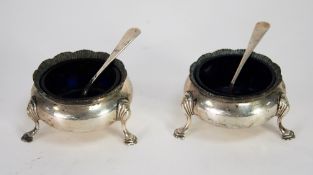 PAIR OF GEORGIAN STYLE CIRCULAR OPEN SALTS, with wavy gadroon edge and raised on three scroll