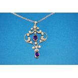 EDWARDIAN GOLD COLOURED METAL OPEN SCROLLWORK PENDANT, set with seed pearls, with collet set centre,