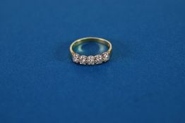 an 18ct YELLOW AND WHITE GOLD FIVE STONE DIAMOND SET HALF HOOP RING, each stone approx 0.10ct gross