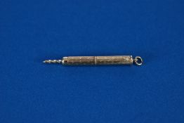 A MODERN 9ct GOLD RETRACTABLE CIGAR PIERCER, with suspension ring, hallmarked Sheffield 1978, 6.3gms