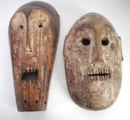 TWO AFRICAN CARVED WOOD MASKS with traces of white pigment, Fang, Gabon, 15 ½" (39.4cm) high and