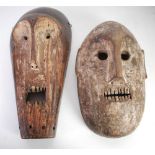 TWO AFRICAN CARVED WOOD MASKS with traces of white pigment, Fang, Gabon, 15 ½" (39.4cm) high and