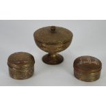 TWO MIDDLE EASTERN CIRCULAR BRASS BOXES AND COVERS with silver coloured metal and copper decoration,