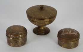 TWO MIDDLE EASTERN CIRCULAR BRASS BOXES AND COVERS with silver coloured metal and copper decoration,