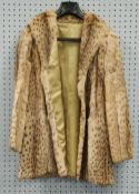 LADY'S LYNX 3/4 LENGTH FUR COAT, with shawl collar, hook fastening double breasted front and a