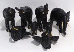 SIX INDIAN EBONY GRADUATED ELEPHANTS WITH IVORY TUSKS, also a pair of matching wall masks all dating