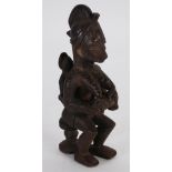 YORUBA CARVED WOOD MATERNITY FIGURE WITH SCARIFICATION, modelled seated with a baby breast feeding