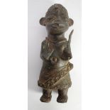 BENIN TYPE CAST BRONZE MALE FIGURE, modelled standing, wearing ceremonial dress and carrying a