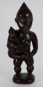 POSSIBLE YOMBE CARVED WOOD MATERNITY FIGURE, modelled standing, carrying a child at her side, her