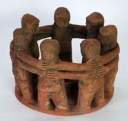 AN AGED POSSIBLY PRE-COLUMBIAN MAYAN (YUCATAN, SOUTHERN MEXICO) TERRA COTTA 'CIRCLE OF FIRENDS'