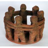 AN AGED POSSIBLY PRE-COLUMBIAN MAYAN (YUCATAN, SOUTHERN MEXICO) TERRA COTTA 'CIRCLE OF FIRENDS'