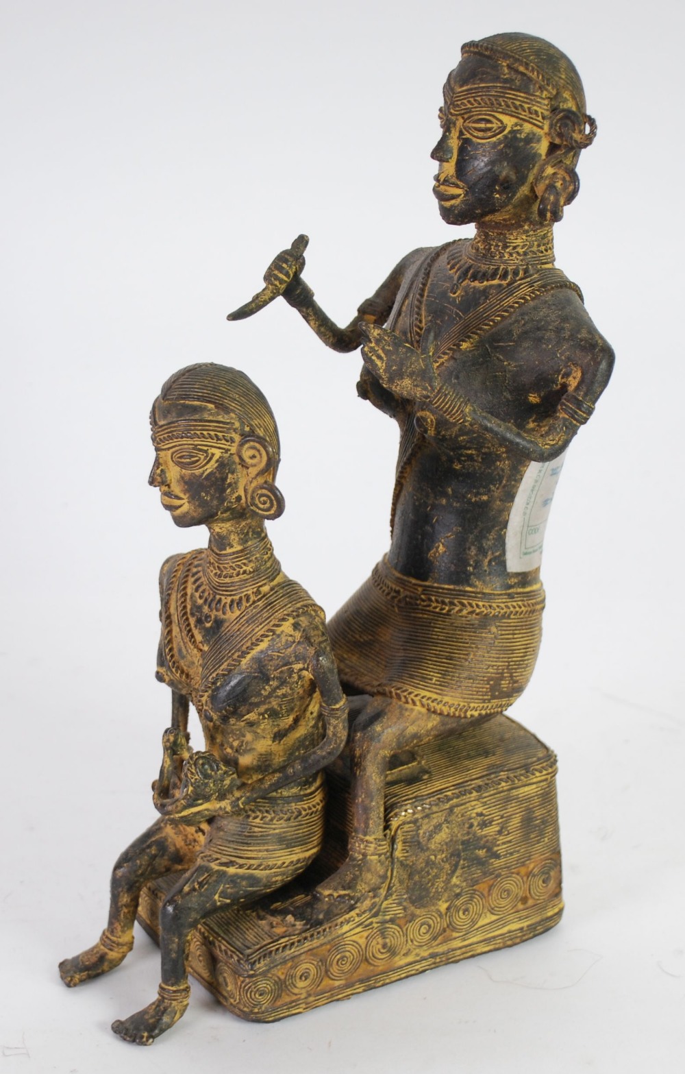 PROBABLY AFRICAN CAST BRONZE OR BRASS CEREMONIAL GROUP, modelled as two ladies seated, one holding a