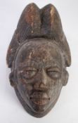 PUNU CARVED WOOD MAIDEN SPIRT MASK, Gabon, with high, ribbed, coiffure and diamond scarification