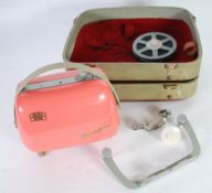 1950s ZEISS-IKON 'MOVILUX' PINK CASED PORTABLE CINE PROJECTOR in a hard vanity-type outer case