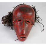 ANGOLA TYPE CARVED WOOD MASK, with red pigment and natural fibre wig, 10" (25.4cm) high