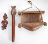 THREE AFRICAN WOODEN ARTIFACTS comprising: a small hand weaving loom? With string suspension, 6 ½" x