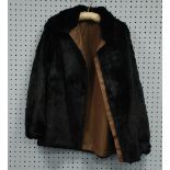 LADY'S BLACK SEAL SKIN JACKET, reversible with a brown gabardine water proof lining, zip front,