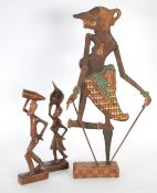 CELONESE, INDIAN HAND PAINTED WOODEN SILHOUETTE PUPPET with moveable arms on an oblong base, 21 1/2"