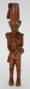 AFRICAN CARVED HARD WOOD FIGURE modelled as a soldier with side drum, 13" (33cm) high