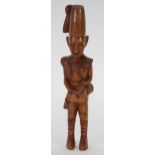 AFRICAN CARVED HARD WOOD FIGURE modelled as a soldier with side drum, 13" (33cm) high