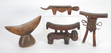 FOUR AFRICAN CARVED WOOD HEAD OR NECK RESTS, including a Lobi example and another of Pokot type(4)