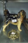 A MELLA WARE PORCELAIN STANDING DOG, ANOTHER SIMILAR AND A JOHN PEEL BRASS DOOR KNOCKER (3)