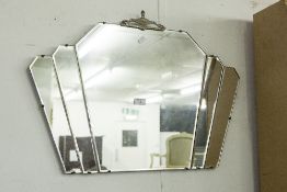 AN ART DECO FAN WALL MIRROR, WITH WHITE METAL URN DETAIL TO THE TOP