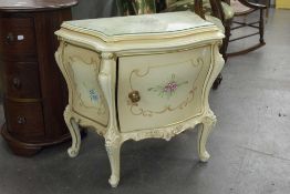 A PAIR OF FRENCH STYLE SERPENTINE BEDSIDE TABLES, CREAM PAINTED WITH SCROLL AND FLORAL DECORATION,