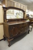 AN EARLY TWENTIETH CENTURY MAHOGANY SHALLOW BOW FRONT SIDEBOARD, WITH MIRRORED BACK