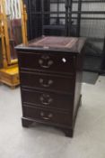 A MODERN DARK WOOD FILING CABINET, THE TOP WITH CLARET LEATHER INSET AND GILT DETAIL, THE DRAWERS