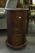 A MAHOGANY CIRCULAR BEDSIDE CHEST OF THREE DRAWERS