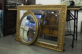 AN EARLY TWENTIETH CENTURY GILT FRAMED RECTANGULAR WALL MIRROR, WITH BEVEL GLASS AND A SMALLER