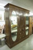 LATE NINETEENTH CENTURY INLAID OAK BEACONSFIELD TYPE WARDROBE WITH TWO OVAL MIRROR PANEL DOORS (A.