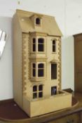 A WOODEN DOLLS HOUSE