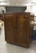 A CHINESE CARVED MAHOGANY TWO DOOR CABINET