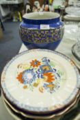 A STUDIO POTTERY LARGE CIRCULAR PLAQUE, THREE RACK PLATES, A BLUE POTTERY AND PRINT DECORATED