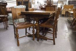 A CIRCA 1940's CARVED OAK DINING ROOM SUITE OF SIX PIECES, COMPRISING; A DRAW-LEAF TABLE, FOUR